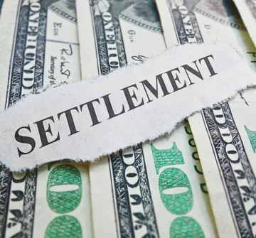 Settlement newspaper headline on money. Can Personal Injury Settlements Be Garnished