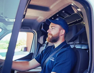 Delivery man sitting in a delivery van. Injured by a Delivery Driver