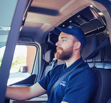 Delivery man sitting in a delivery van. Injured by a Delivery Driver