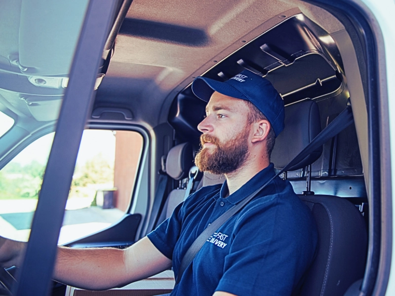 Delivery man sitting in a delivery van. Injured by a Delivery Driver