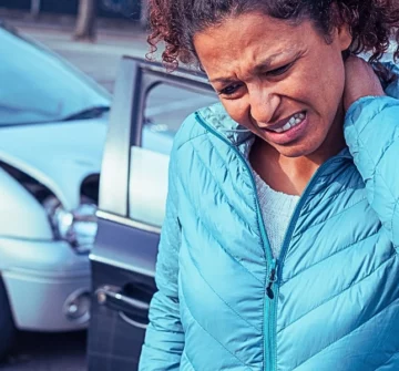 Woman with a painful neck ache after fender bender car crash. Rear-End Collisions in Stop-and-Go Traffic