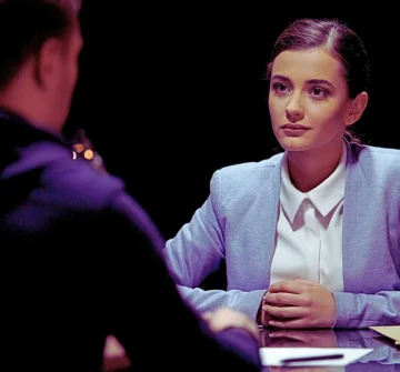 Female lawyer looking at client with smile, giving hope for release from prison. Role of Witness Statements