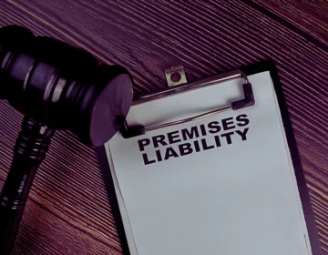 Symbolizes the legal concept of premises liability, specifically in the context of a potential lawsuit or court case. Injured on Someone Else’s Property in Cincinnati