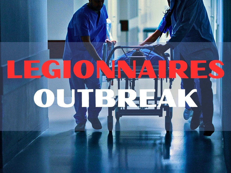 Medical staff wheeling a patient through a hallway.