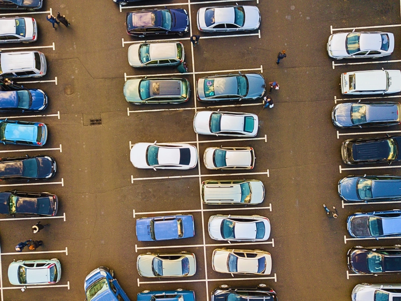 Aerial view of cars parked in a lot. Dangerous Parking Lots