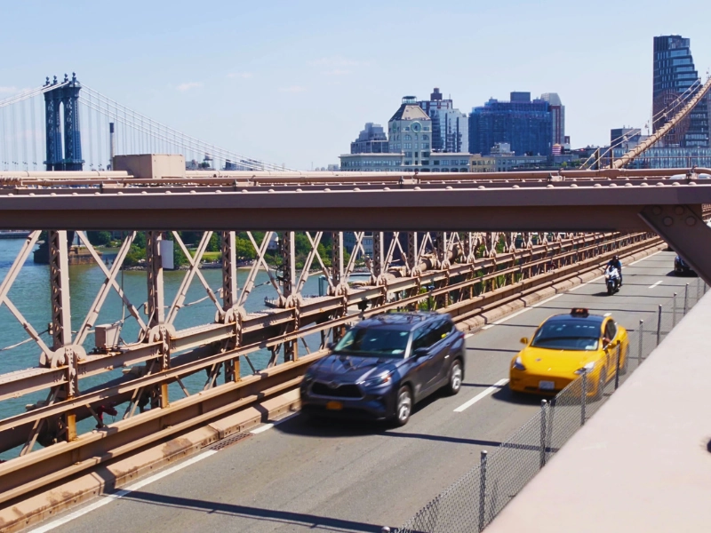 Cars driving across the iconic Brooklyn Bridge in New York. Bridge and Ramp Accidents in Cincinnati