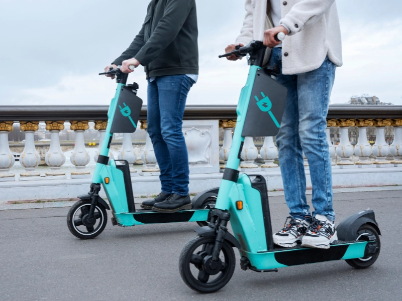 Two men using an electric e-scooter. Sue After an Electric Scooter Accident