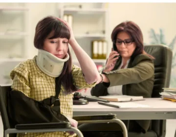 A woman wearing a neck brace sits in her lawyer's office, worried that her workers' compensation may not be enough to cover her accident. If Workers’ Comp Doesn’t Cover All Your Injuries