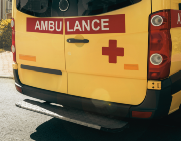 Rear view of a yellow ambulance.
