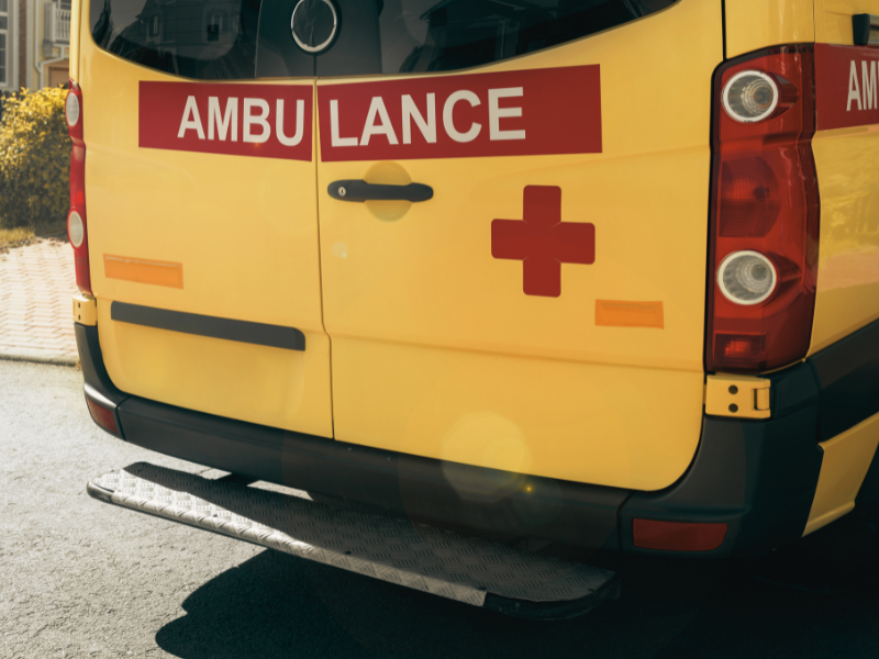 Rear view of a yellow ambulance.