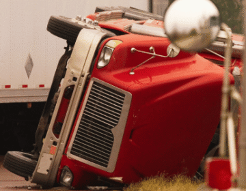an overturned red truck