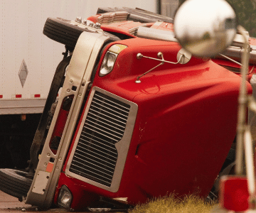 an overturned red truck