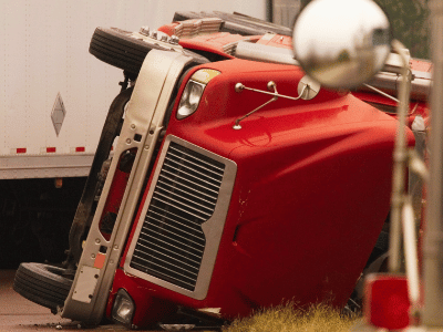 an overturned red truck