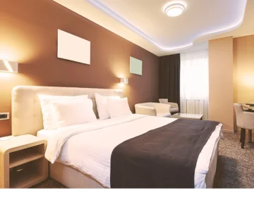 A tidy brown and tan hotel room where someone was injured.