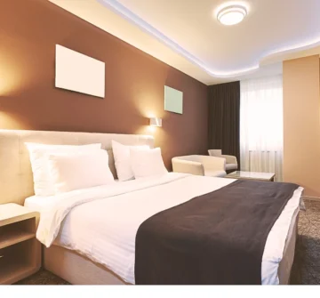 A tidy brown and tan hotel room where someone was injured.